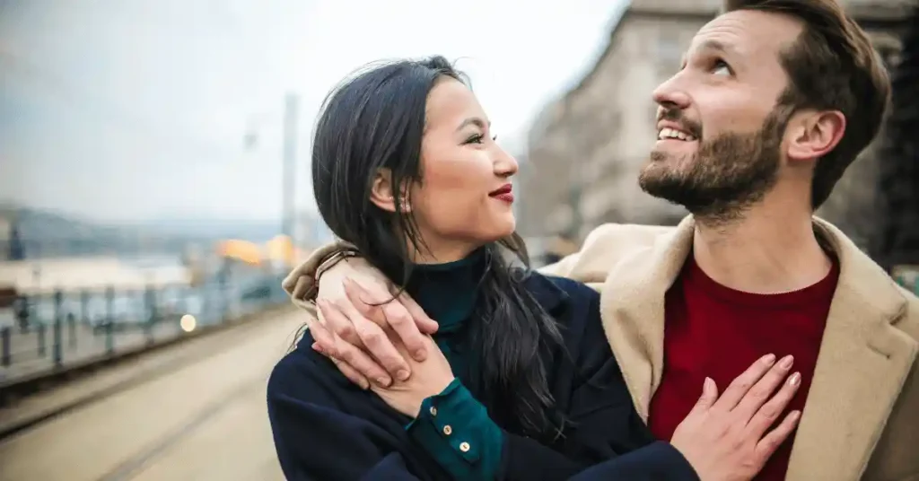 A girl is hugged by her sponsor, who helps her with an AOS or AOSG for a Chinese visa application.