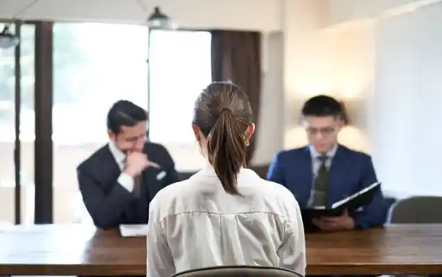A woman is being interviewed by Chinese visa officer, and she is explaining why her previous visa application was rejected.