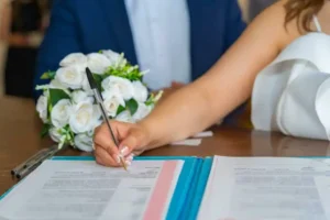 A Filipino woman prepares to sign the LCCM she received before having a China marriage.