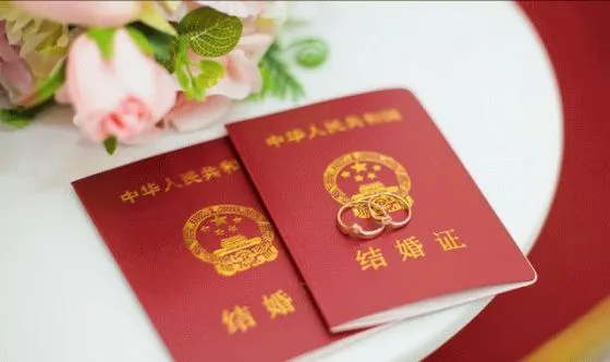 On the table were two Chinese marriage certificates, along with two wedding rings.