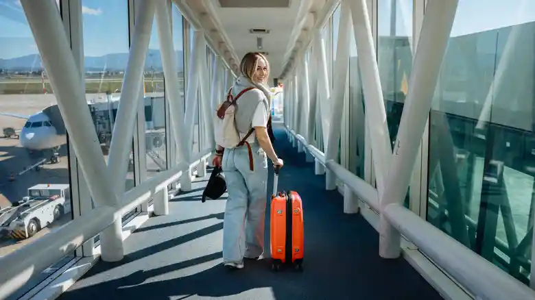 Following travel advice, a female traveler holding a China tourist visa walked towards the plane, ready to leave.