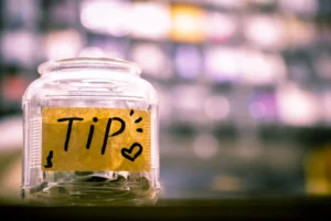 A table sits a jar labeled "tip" containing notes about visa mistake, approval, and visa tips regarding the Chinese visa.