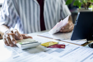 A Philippine bank employee is using a bank card to process a bank statement for a Chinese visa application.