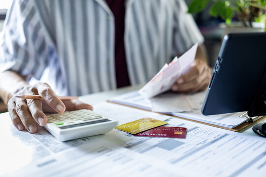 A Philippine bank employee is using a bank card to process a bank statement for a Chinese visa application.