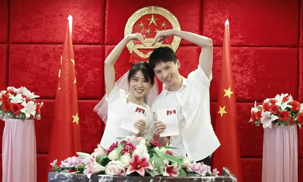 a happy couple who just got married in china ,holding their certificate of marriage together