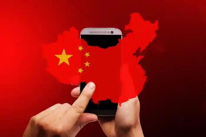 a flag of china above a electronic gadget symbolizing china firewall