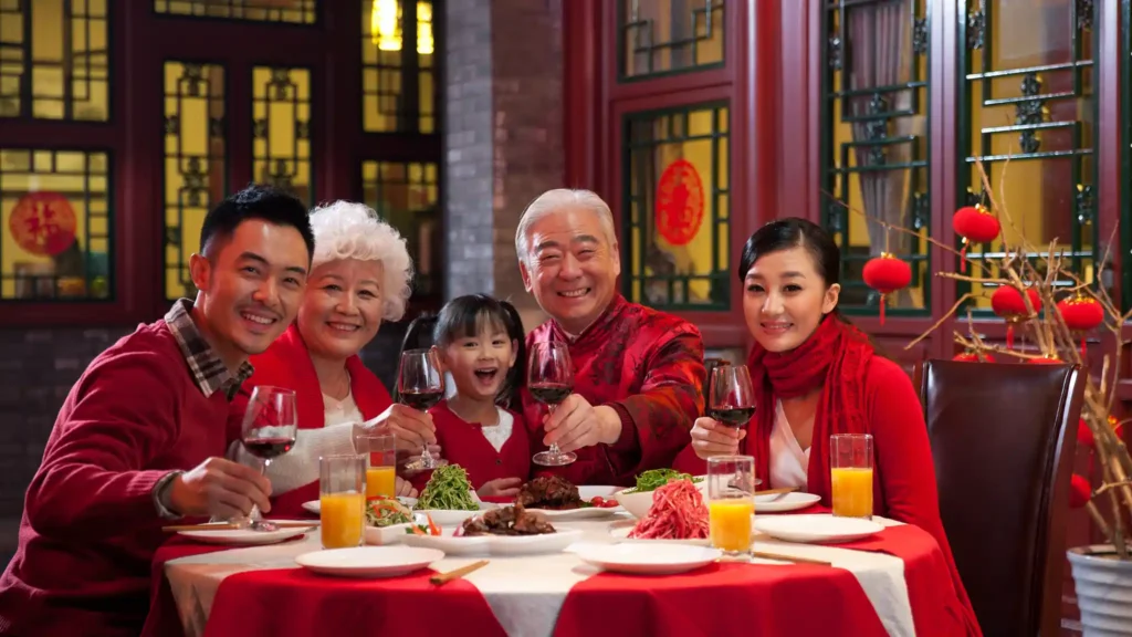 a chinese family whose dining together and happily eating together