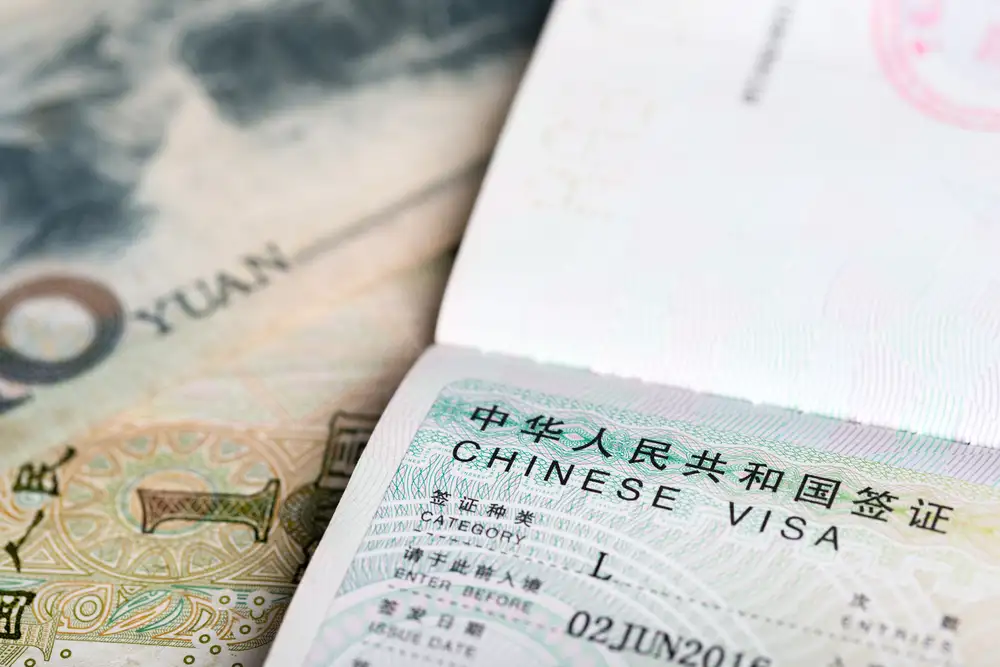 example of a L chinese visa or tourist visa and a photo of a chinese yuan
